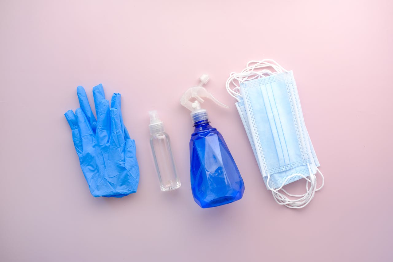 The Art of Drawing Readers In: Your attractive post title goes here Flat lay of protective gear including gloves, sanitizer, and masks on a pastel pink background.