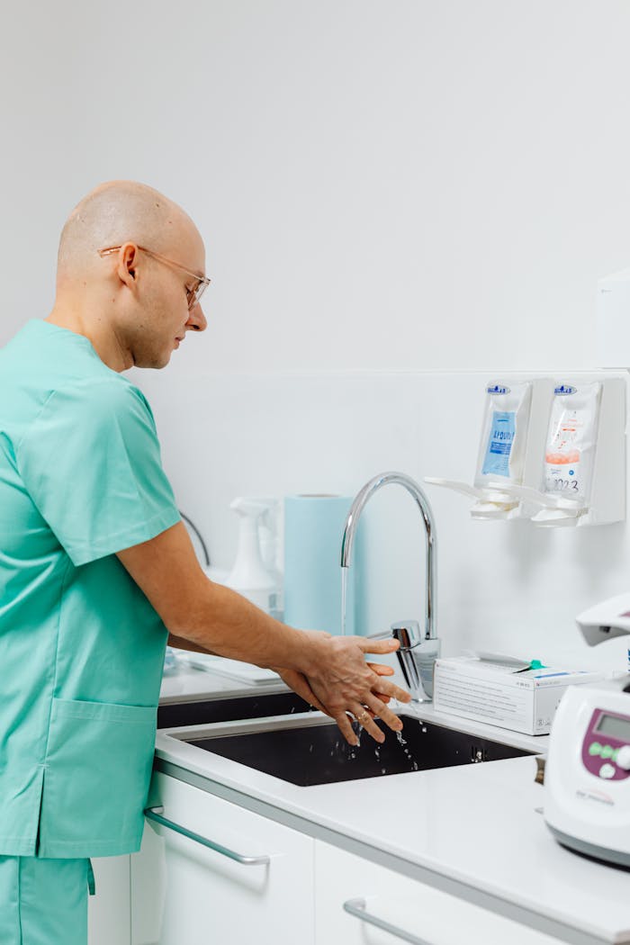 Crafting Captivating Headlines: Your awesome post title goes here A doctor in scrubs washes hands at a medical facility sink, promoting hygiene and healthcare practices.