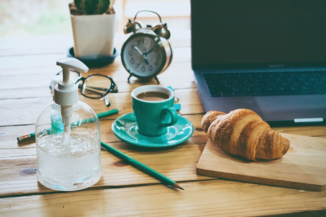 services-img A rustic workspace featuring coffee, croissant, laptop, and essentials on a wooden table.